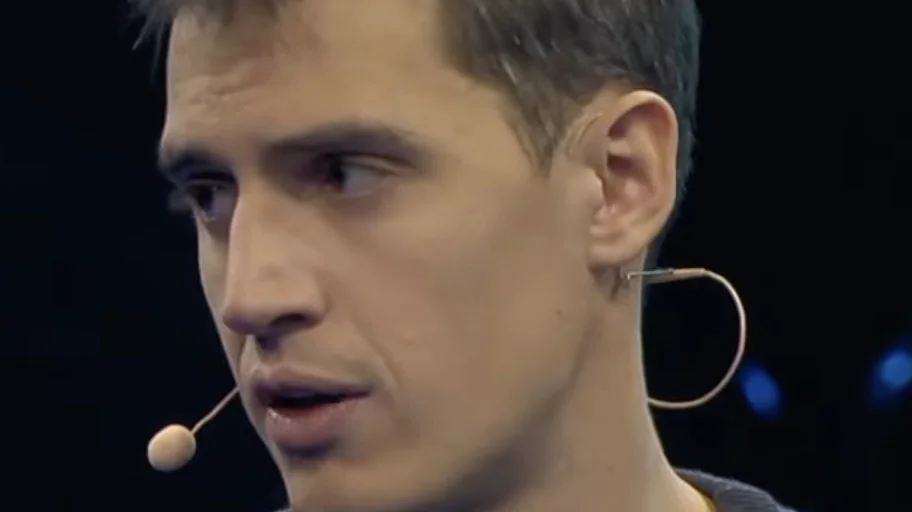 Mistral co-founder and CEO Arthur Mensch speaking on stage, wearing a headset microphone.