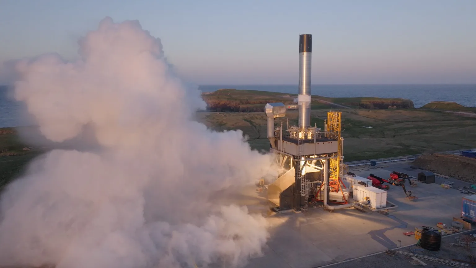 RFA One first stage venting and firing vertically on the test stand at SaxaVord Spaceport at dusk.