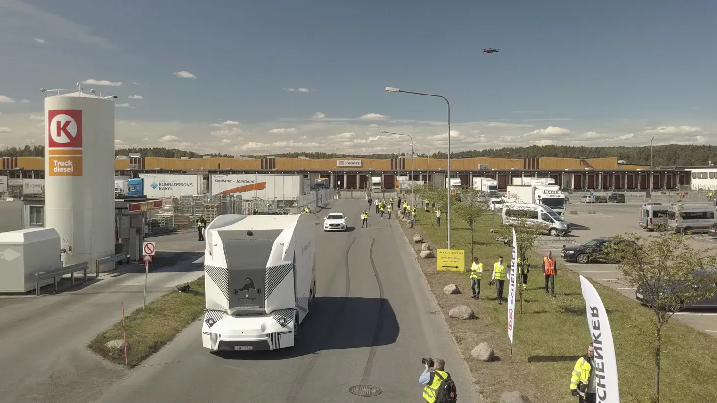 Einride's cab-less electric truck driving past spectators at DB Schenker's Jönköping facility.