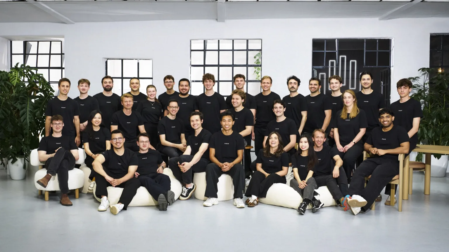 The microagi team gathered in its office wearing matching black shirts.