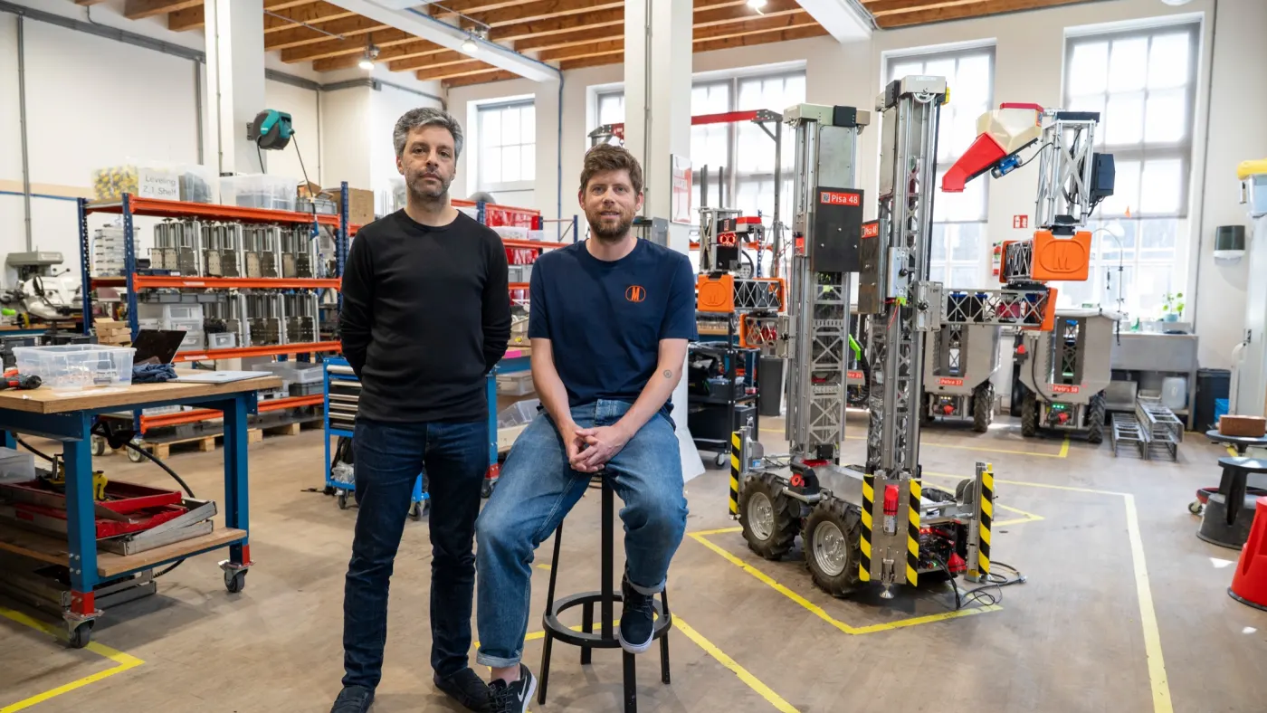 Monumental co-founders Salar al Khafaji and Sebastiaan Visser standing in the company's Amsterdam robot workshop.