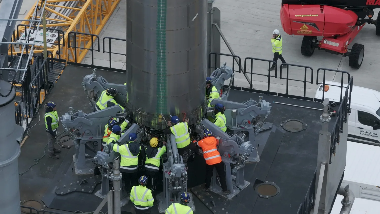 Crew in hi-vis gear installing an RFA One stage onto the launch mount at SaxaVord.
