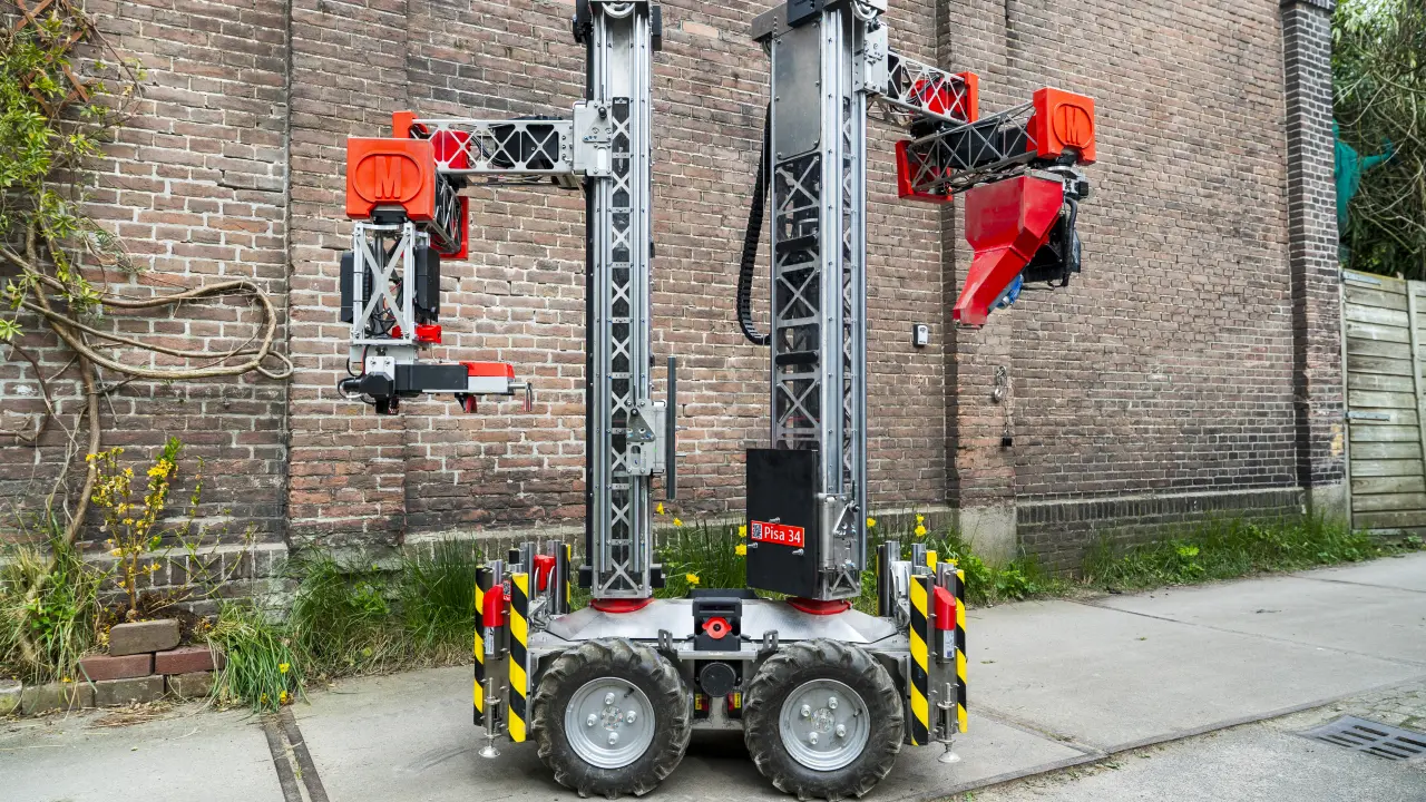 A compact Monumental bricklaying robot with twin vertical masts and two articulated tool arms.
