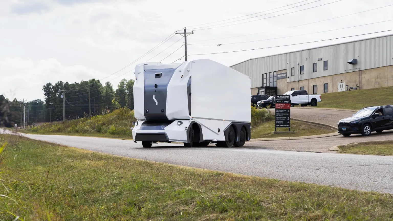 Einride's cab-less electric truck driving on a public road outside a GE Appliances facility in Tennessee.